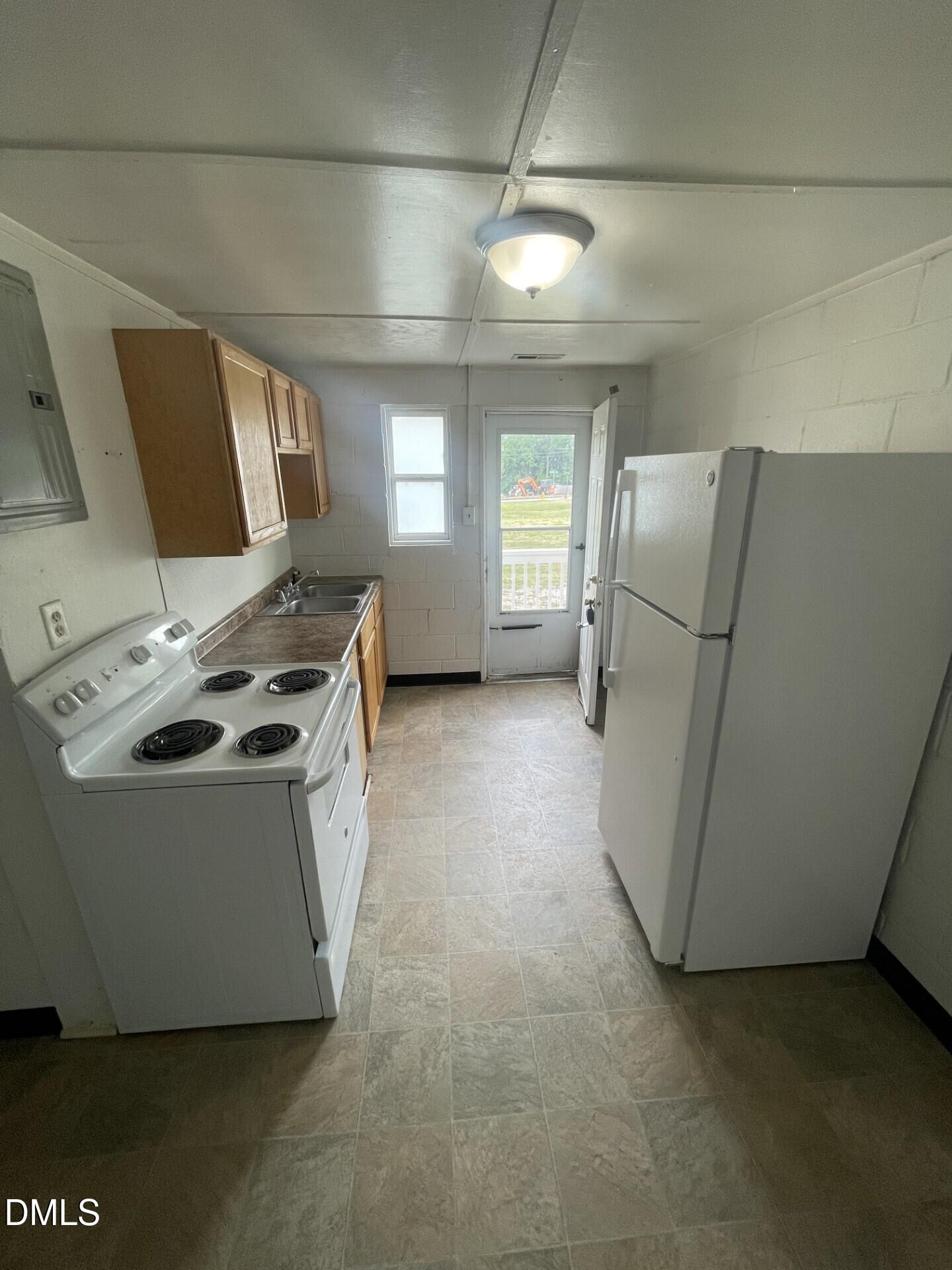 1119 Gregg Street Raleigh, NC 27601 - Photo 4 of 12 a view of a kitchen with fridge and wooden floor