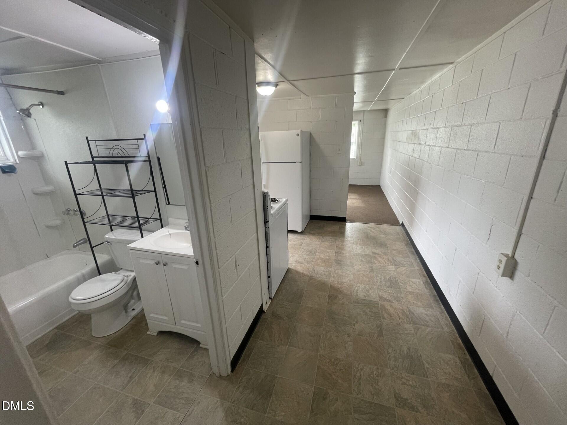 1119 Gregg Street Raleigh, NC 27601 - Photo 6 of 12 a bathroom with a toilet a sink and shower