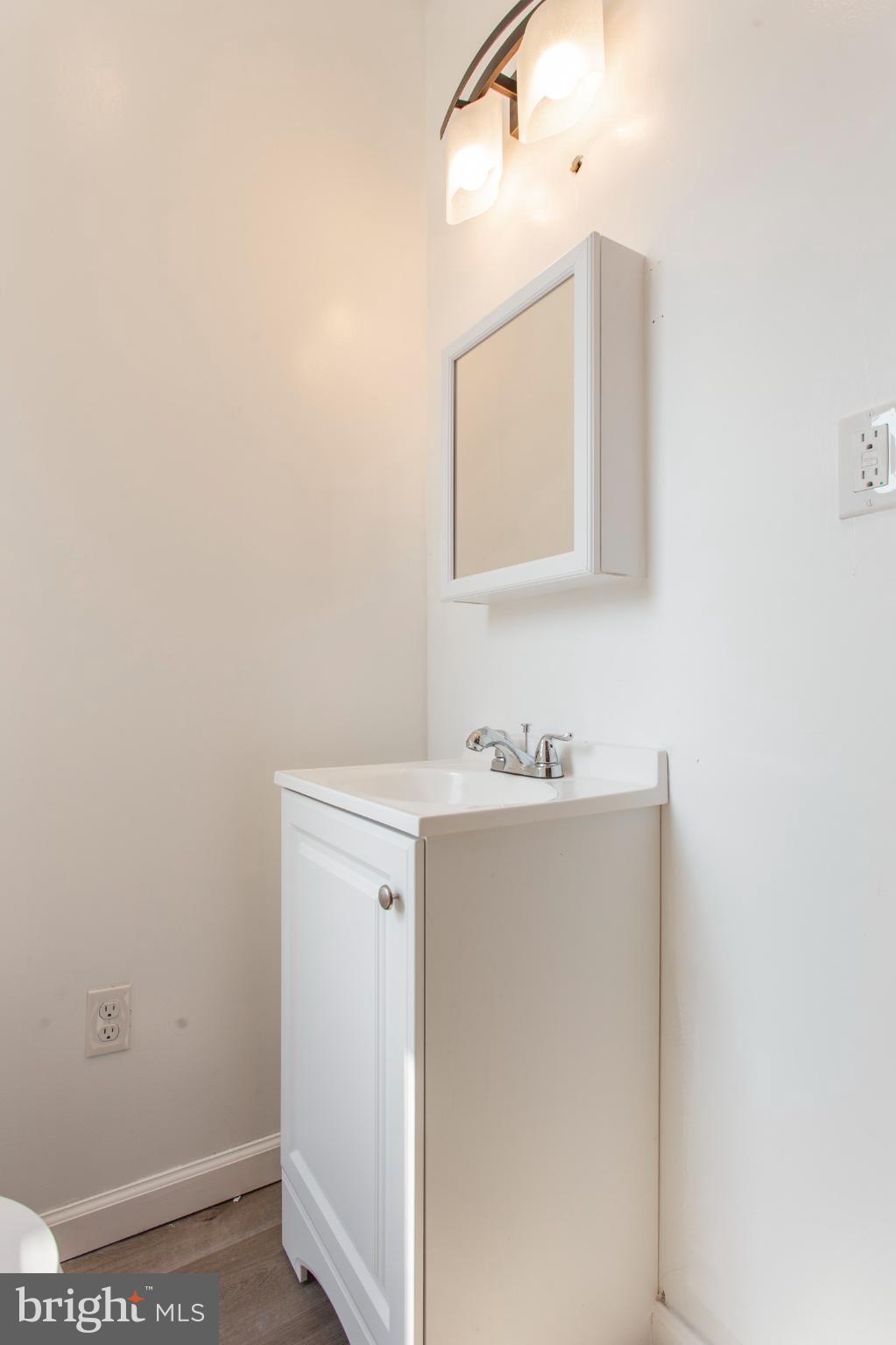 5330 Pentridge Street Philadelphia, PA 19143 - Photo 7 of 14 a bathroom with a sink a mirror and vanity