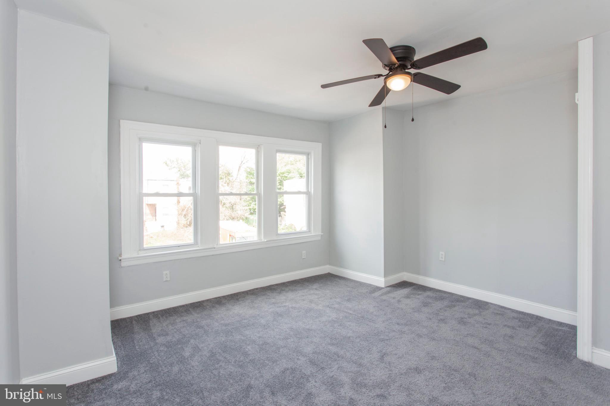 5330 Pentridge Street Philadelphia, PA 19143 - Photo 8 of 14 an empty room with ceiling fan and window