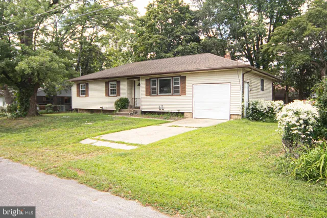 a house that has a big yard with large trees