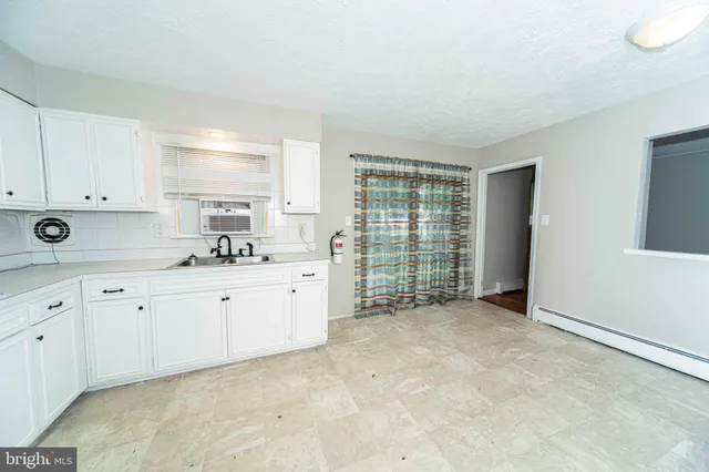 a view of a kitchen with electric appliances