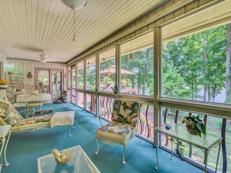 121 Spring Drive Huddleston, VA 24104 - Photo 16 of 70 a living room with furniture and a floor to ceiling window