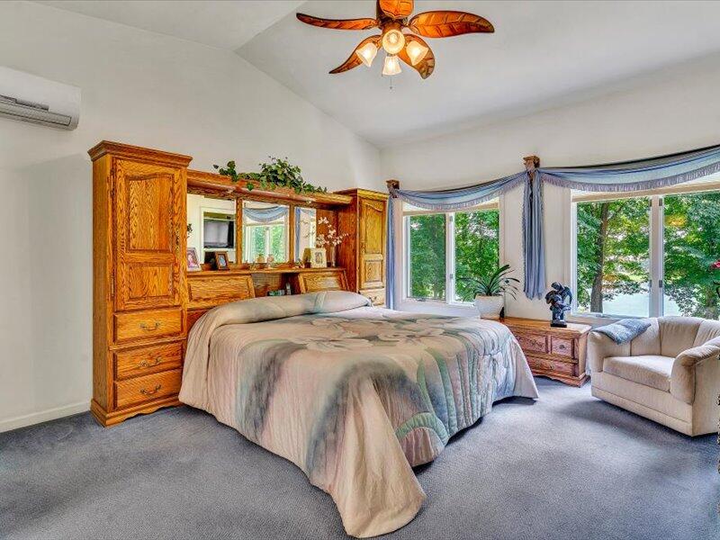 121 Spring Drive Huddleston, VA 24104 - Photo 32 of 70 a spacious bedroom with a bed and a chandelier