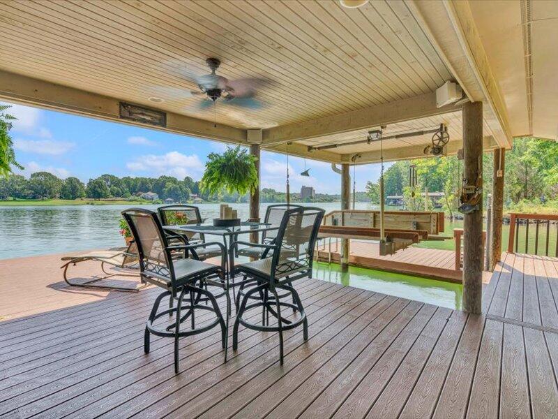 121 Spring Drive Huddleston, VA 24104 - Photo 56 of 70 a view of a patio with table and chairs with wooden floor and floor to ceiling window