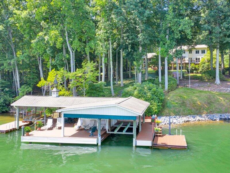 121 Spring Drive Huddleston, VA 24104 - Photo 64 of 70 a view of a patio with table and chairs potted plants and large tree