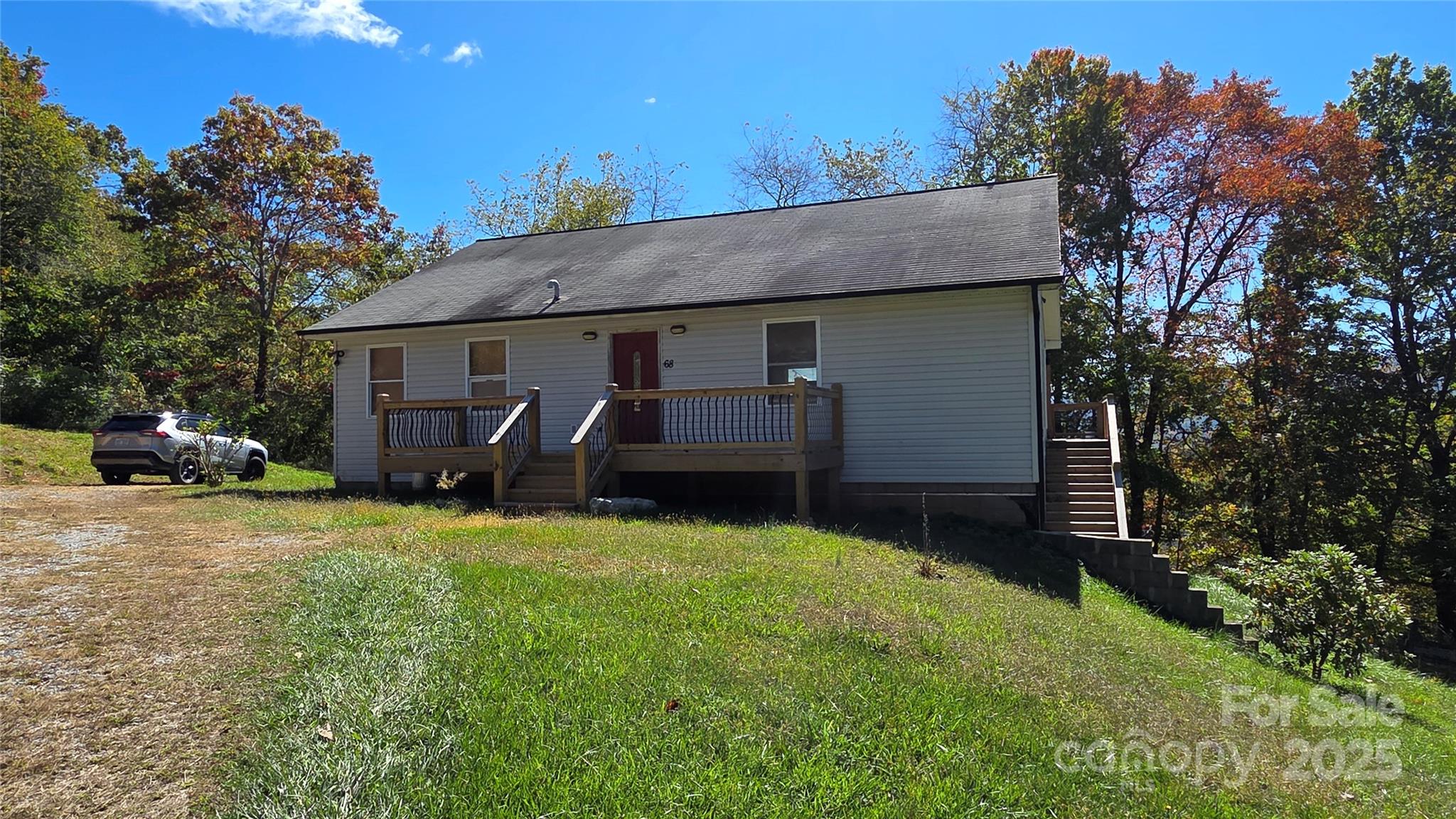 68 Garden Ridge Clyde, NC 28721 - Photo 1 of 16 a view of a house with a yard and garage