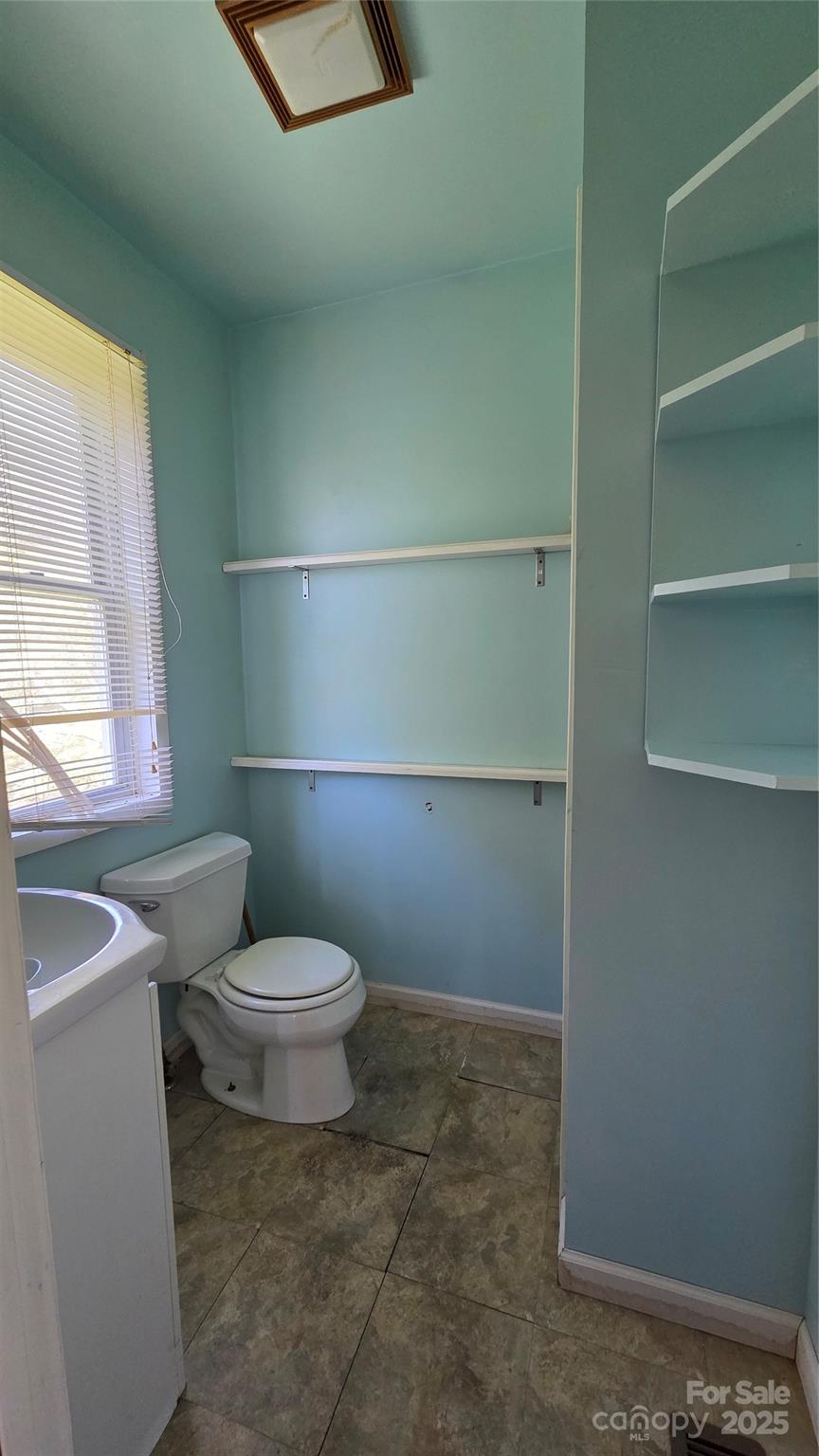 68 Garden Ridge Clyde, NC 28721 - Photo 13 of 16 a white toilet sitting next to a bathroom sink