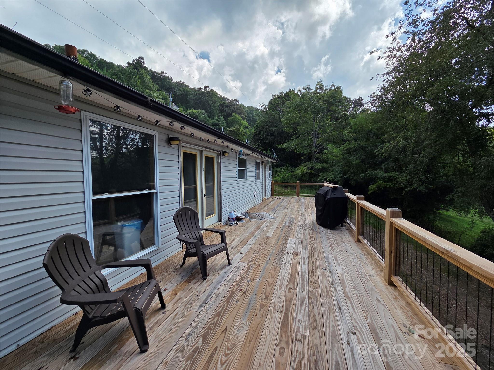 68 Garden Ridge Clyde, NC 28721 - Photo 14 of 16 a balcony with wooden floor and outdoor seating