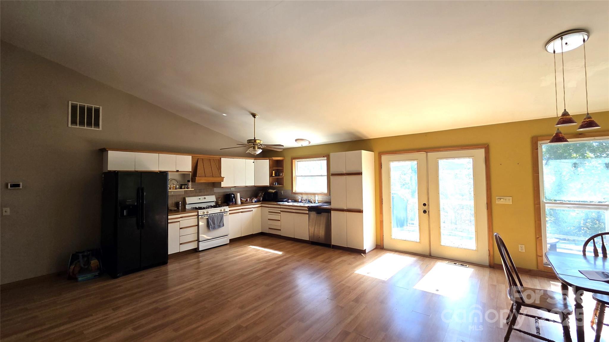 68 Garden Ridge Clyde, NC 28721 - Photo 4 of 16 a kitchen with a wooden floor stove and refrigerator