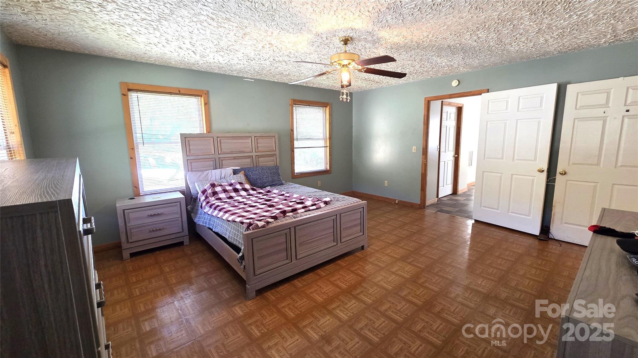68 Garden Ridge Clyde, NC 28721 - Photo 9 of 16 a bedroom with a bed rug and wooden floor