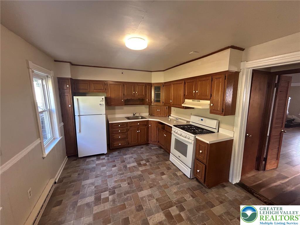 1122 East 4th Street Bethlehem, PA 18015 - Photo 5 of 13 A functional kitchen provides ample cabinetry and essential appliances for everyday living.