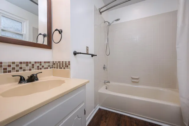 a bathroom with a sink a mirror and a bathtub