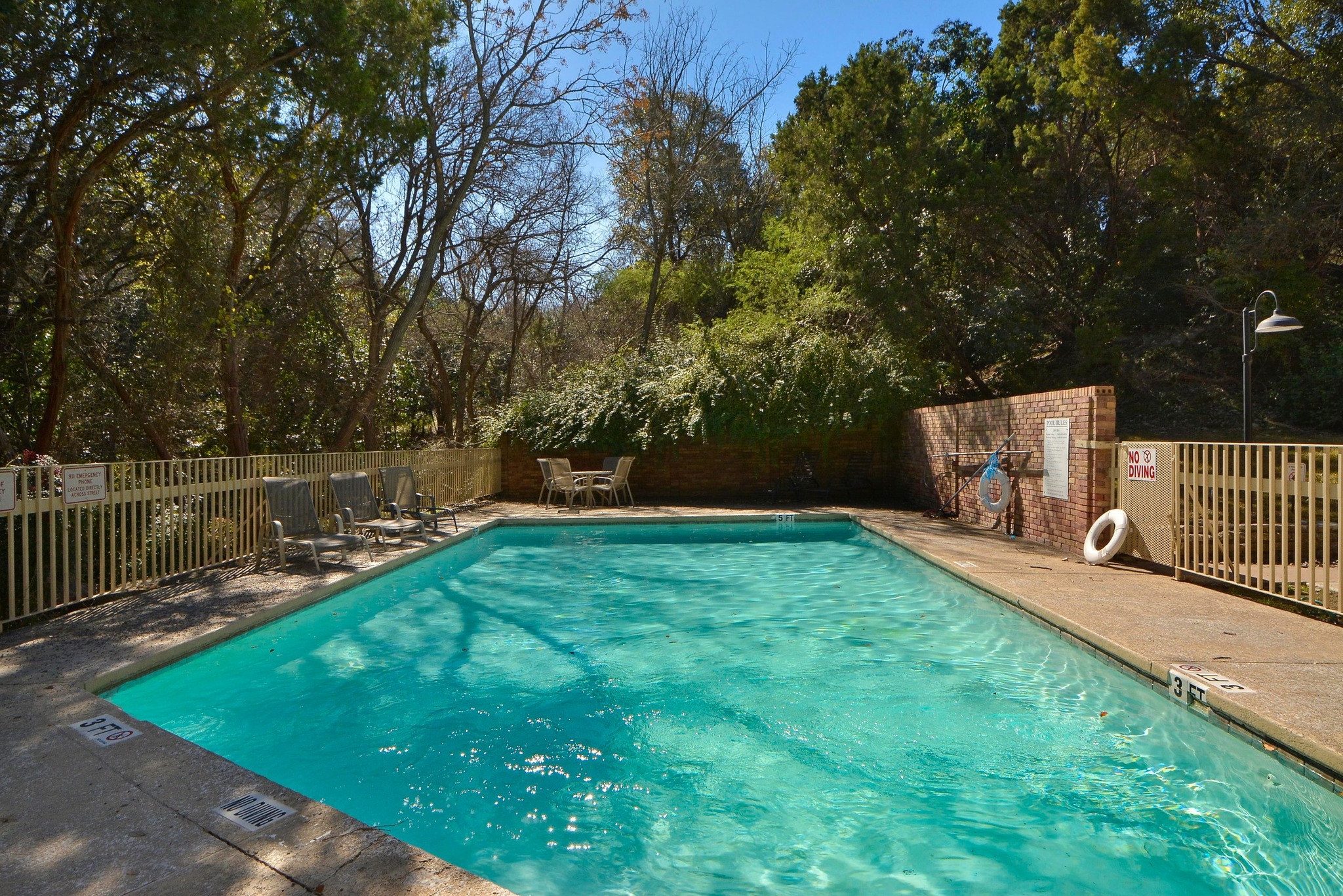 3845 Ranch Road 2222, Unit 19 Austin, TX 78731 - Photo 29 of 38 a view of a backyard with a bench and lake