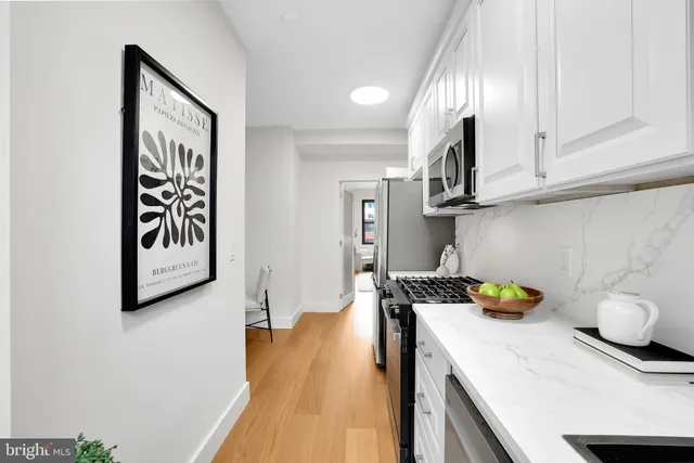 a kitchen with stainless steel appliances granite countertop a sink and cabinets