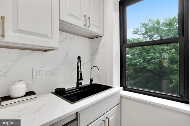a kitchen with a stove and a window