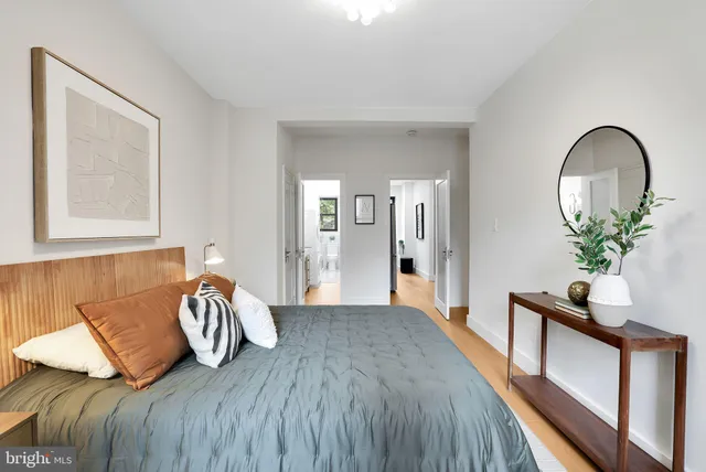 a bed sitting in a bedroom next to a window