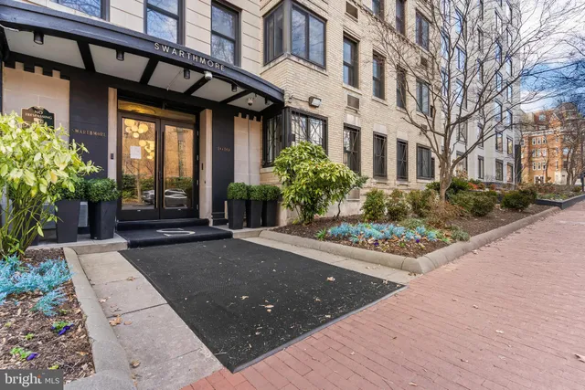 a front view of a house with a potted plant