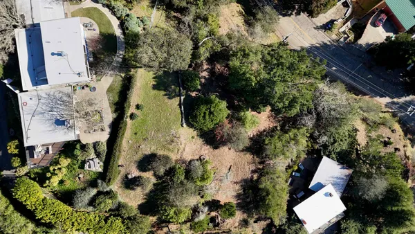 an aerial view of residential house with outdoor space and swimming pool