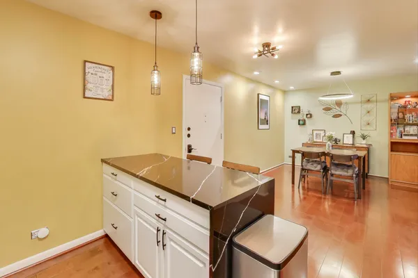 a hallway with a table and chairs