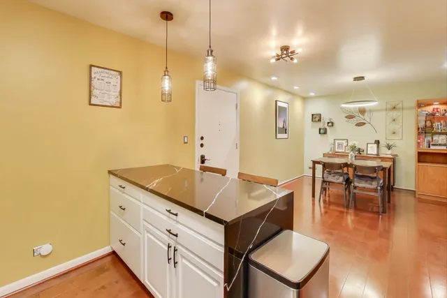 a hallway with a table and chairs