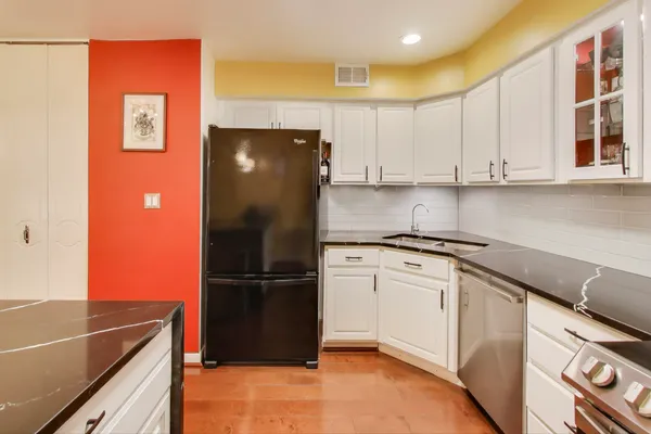 a kitchen with stainless steel appliances granite countertop a refrigerator sink and cabinets