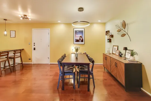 a view of a dining room with furniture and wooden floor