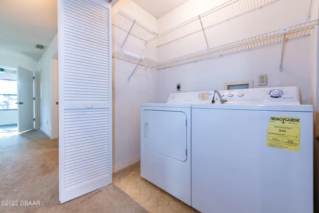 a utility room with cabinets washer and dryer