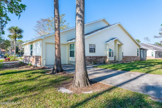 a front view of house with yard and green space