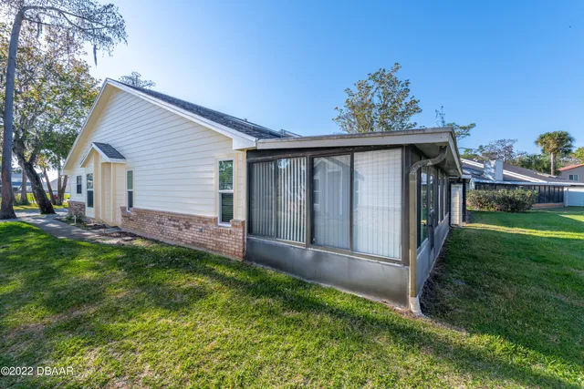 a view of backyard with deck and garden