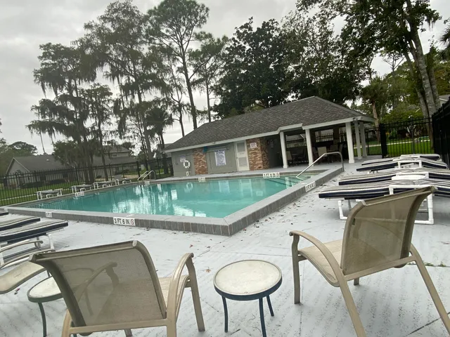 a view of house with backyard outdoor seating and green space