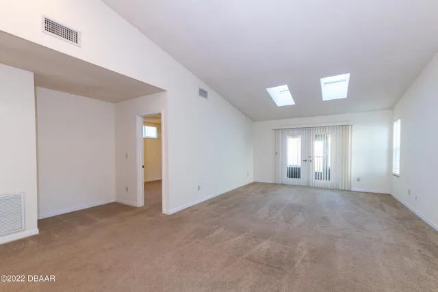 an empty room with windows and closet