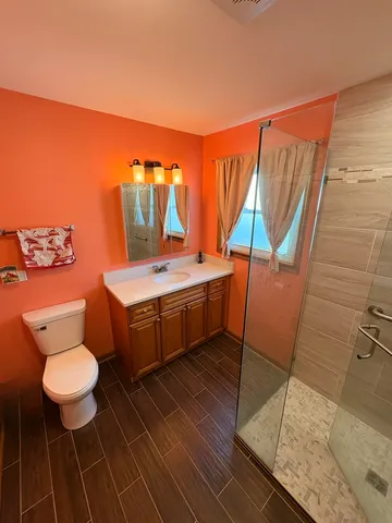a bathroom with a sink toilet and shower