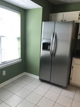 a kitchen with a refrigerator and window