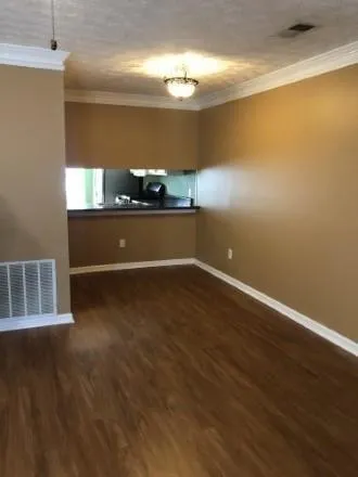 a view of room with window and wooden floor
