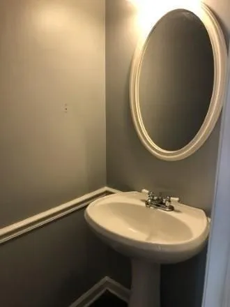 a bathroom with a sink and mirror