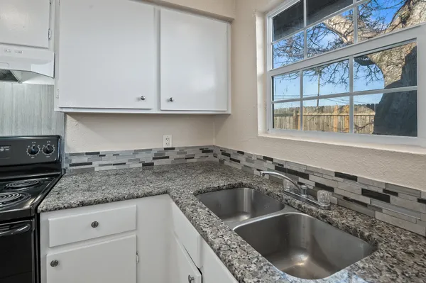 a kitchen with a sink and cabinets