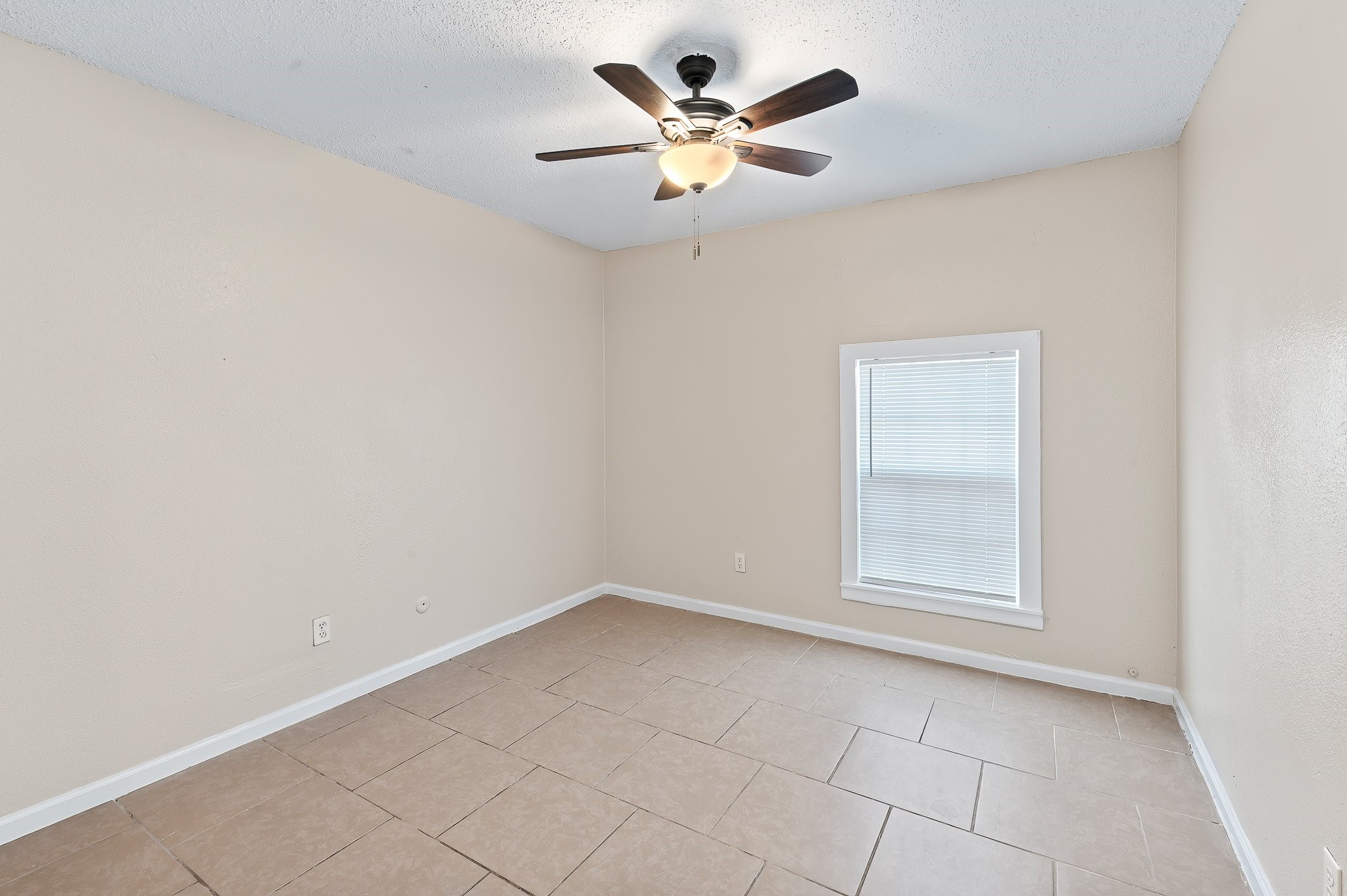 410 Old Thorndale Road, Unit A Taylor, TX 76574 - Photo 22 of 28 an empty room with a window and a fan