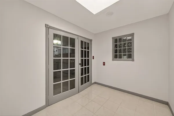 a view of a big room with wooden floor and windows