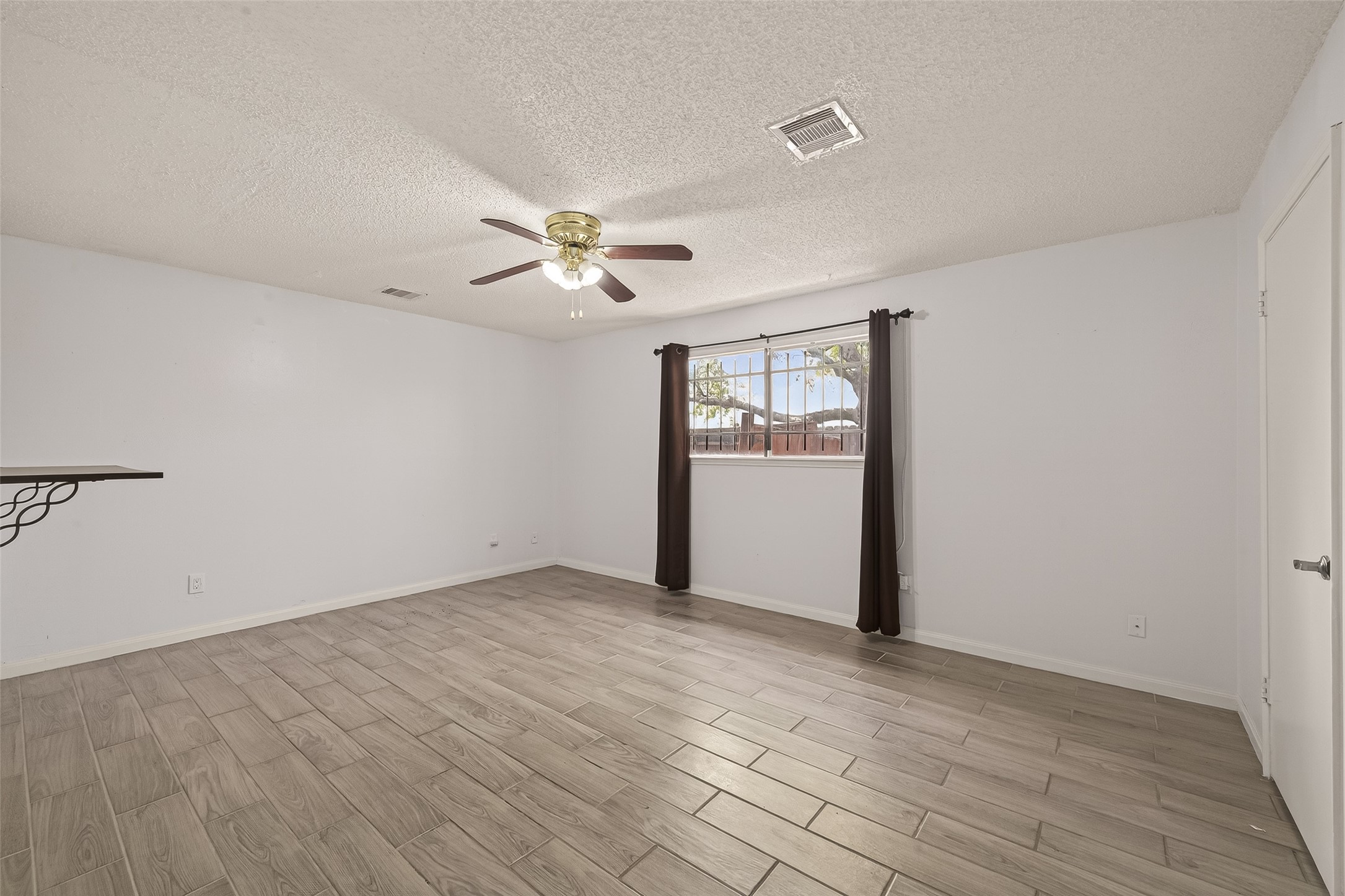 11331 Oakcenter Drive Houston, TX 77072 - Photo 24 of 36 wooden floor in an empty room with a window