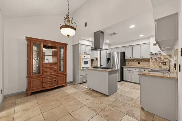 a kitchen with stainless steel appliances granite countertop a sink and cabinets