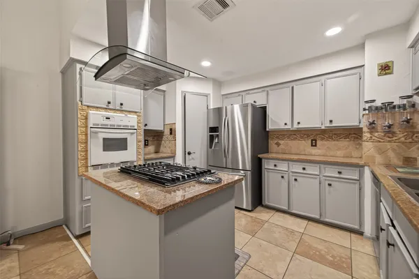 a kitchen with a stove oven and sink