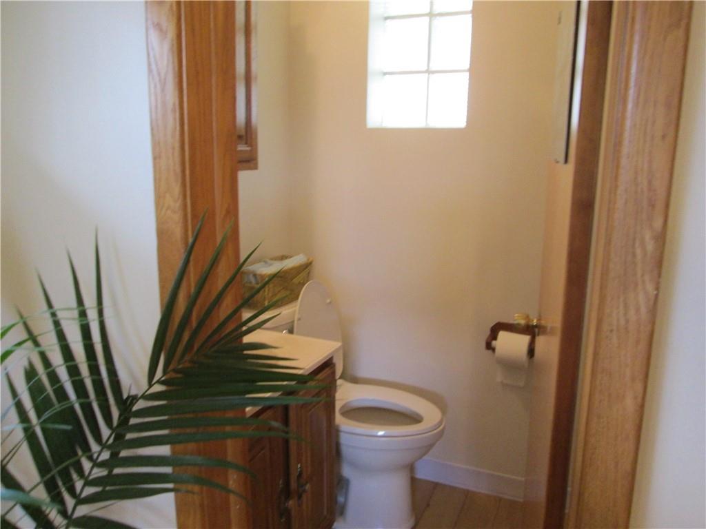 4717 Ellwood Road New Castle, PA 16101 - Photo 22 of 32 a bathroom with a toilet a sink and a mirror