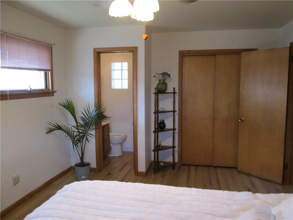 4717 Ellwood Road New Castle, PA 16101 - Photo 24 of 32 a bedroom with a bed and a potted plant