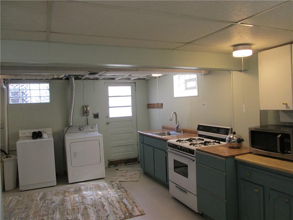 4717 Ellwood Road New Castle, PA 16101 - Photo 26 of 32 a kitchen that has a sink and a stove