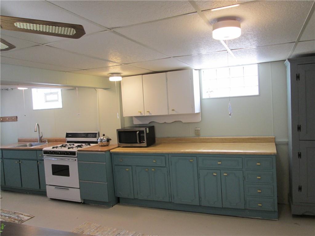 4717 Ellwood Road New Castle, PA 16101 - Photo 27 of 32 a kitchen with a stove and cabinets