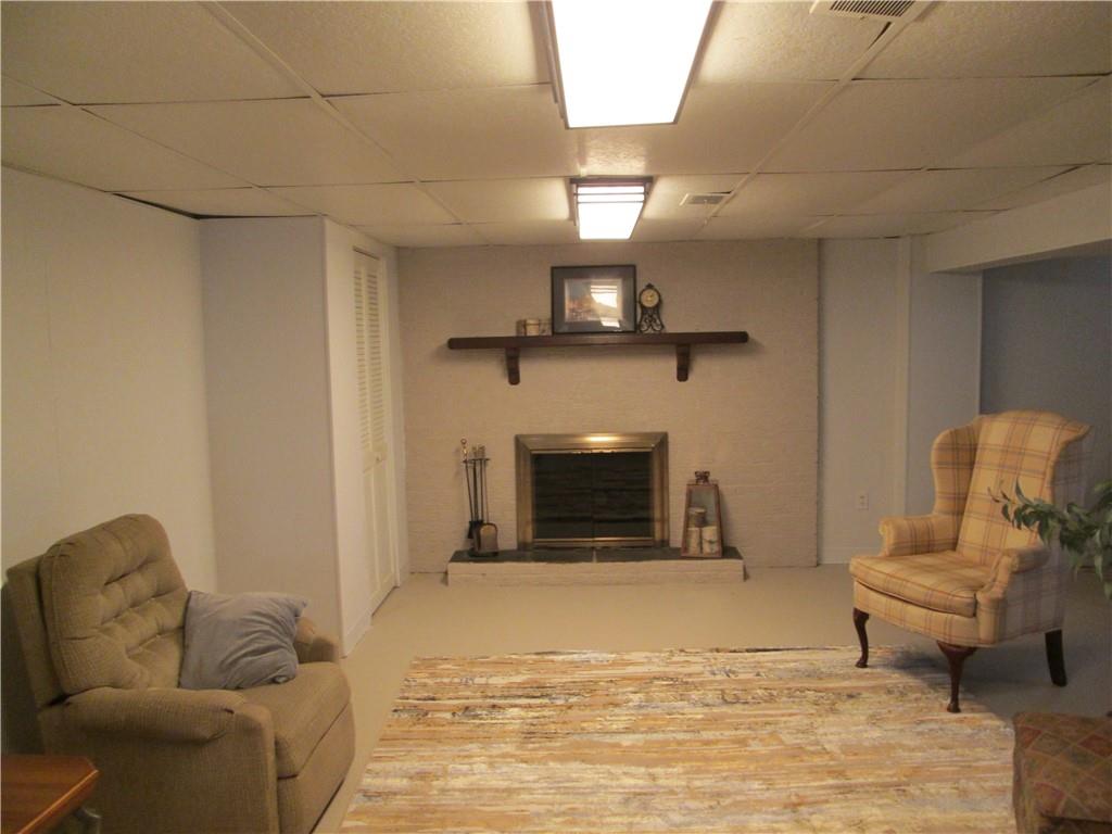 4717 Ellwood Road New Castle, PA 16101 - Photo 31 of 32 a living room with furniture and a fireplace
