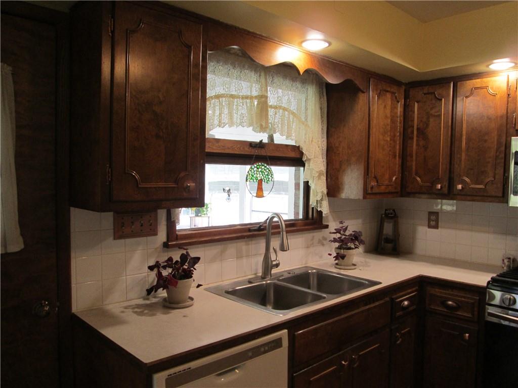 4717 Ellwood Road New Castle, PA 16101 - Photo 5 of 32 a kitchen with a sink and cabinets