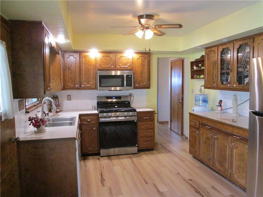 4717 Ellwood Road New Castle, PA 16101 - Photo 6 of 32 a kitchen with stainless steel appliances granite countertop a sink stove and refrigerator