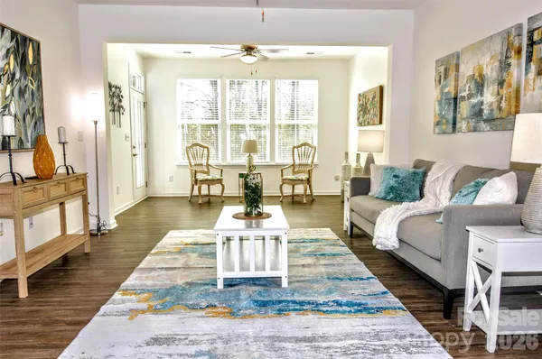 a living room with furniture fireplace and a table